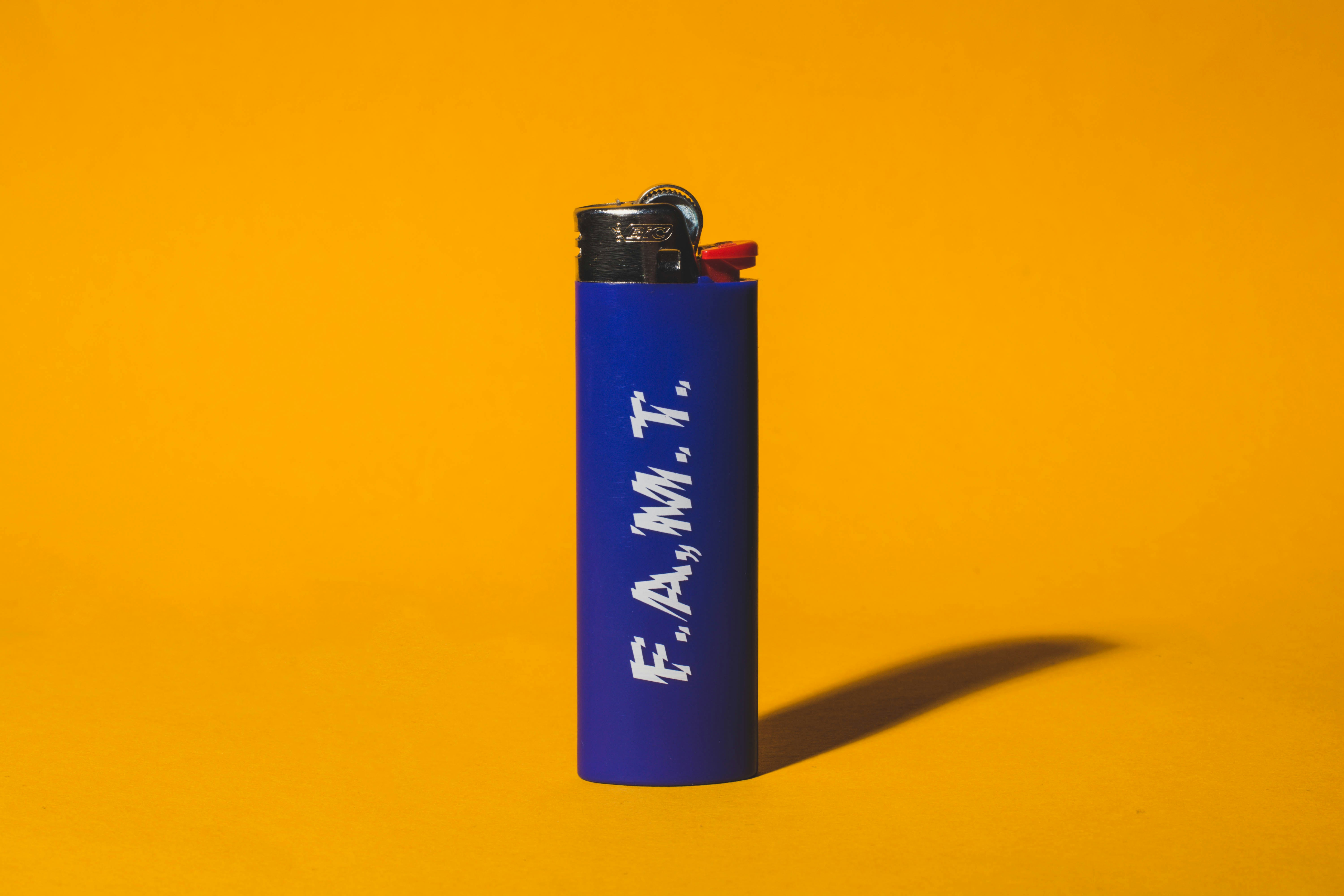 a blue lighter on yellow background